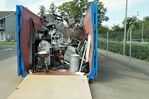 Metal waste collected in a container in a community disposal place. A public service free of charge to prevent littering the environment. Efficient waste management supporting awareness of citizens.
