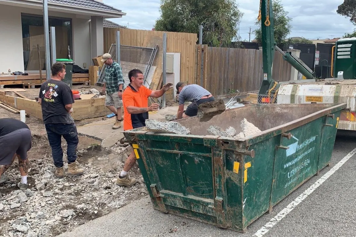 constrcution site with worker and dumpster